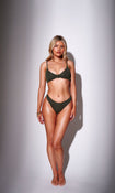 Model wearing a khaki green crinkle fabric bikini top with matching bottoms
