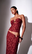 Model wearing a burgundy floral print bandeau top with matching skirt - front view on white background