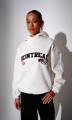 Model wearing a cream hoodie with 'Montreal' graphic text - front view on plain background